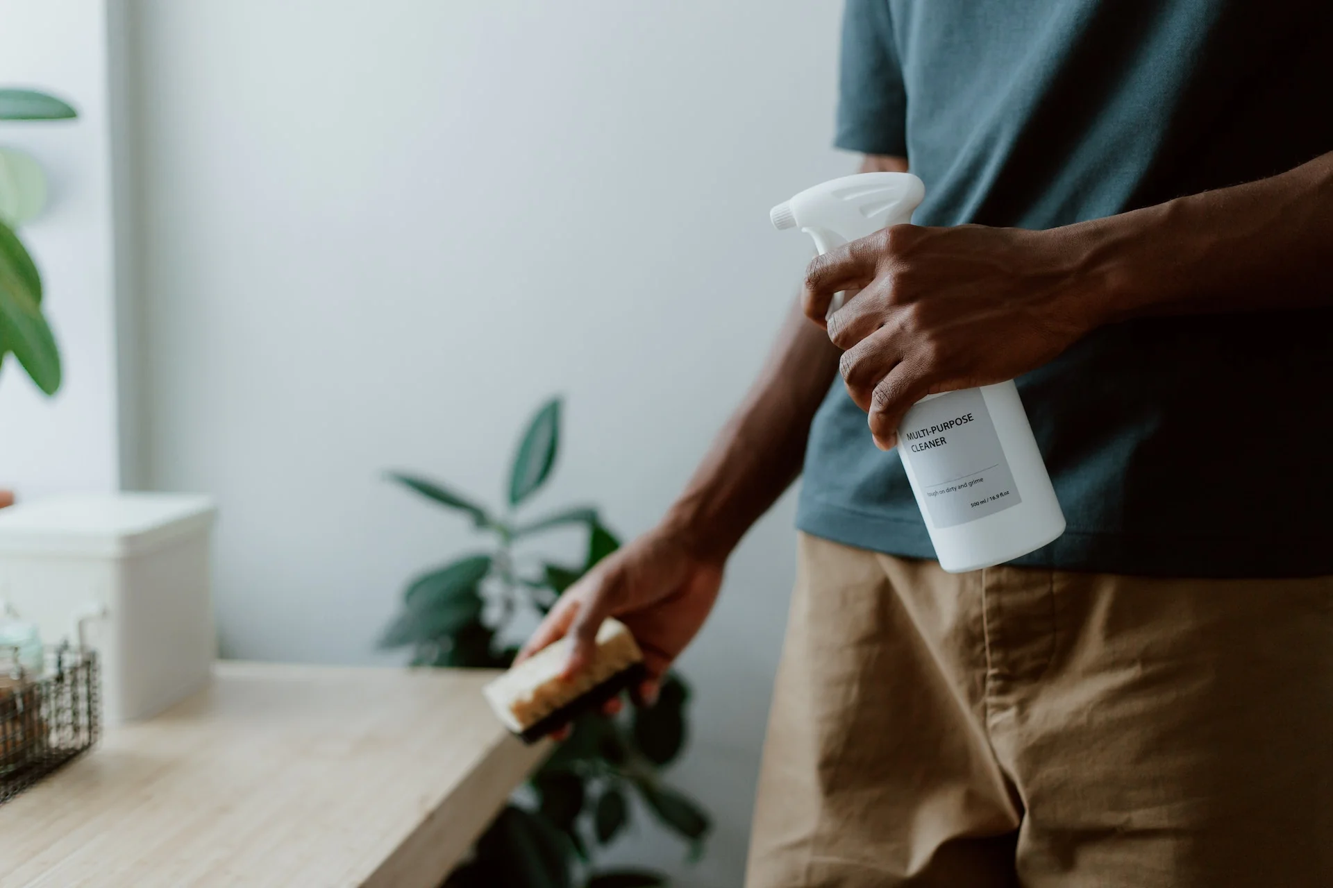 Man cleaning kitchen table
